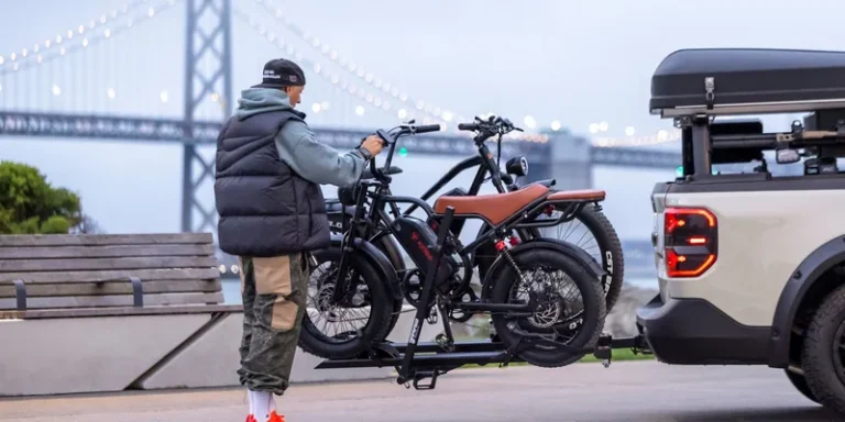 Platformdrager met twee elektrische fietsen achterop een auto